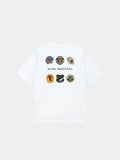 The Alpha Industries Short Sleeve Patched Tee in white with eight military-inspired patches and Alpha Industries text on back.