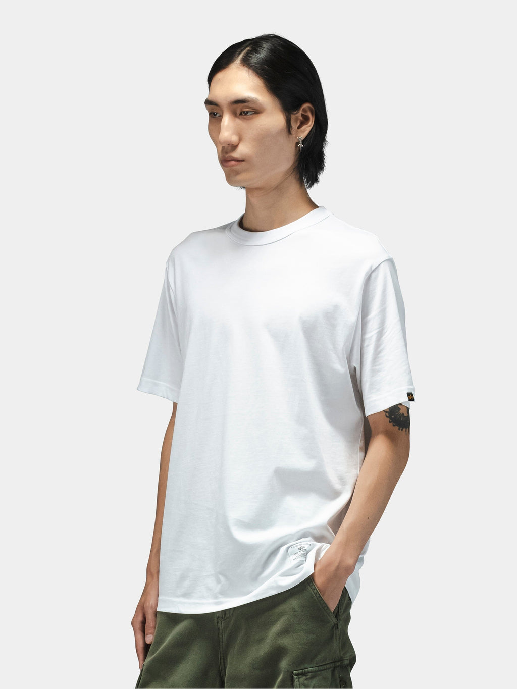 Alpha Industries Short Sleeve Regular Tee in black, paired with green pants.