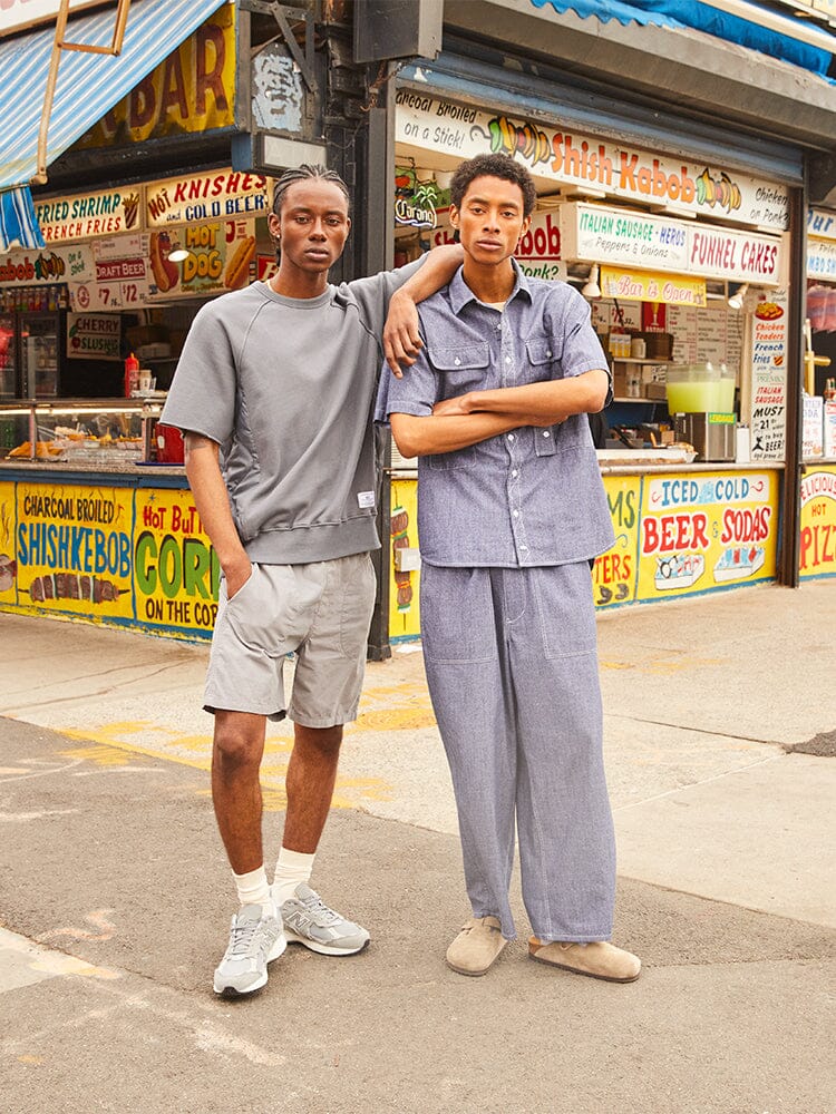 Alpha Industries Short Sleeve Sweatshirt, gray; blue button-up shirt with loose pants.