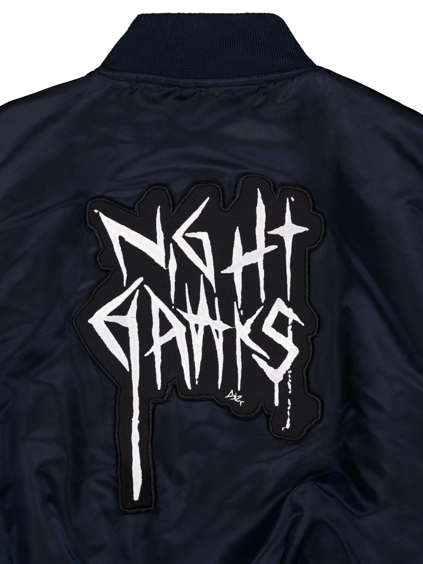 Alpha X 032c Flight Bomber by Alpha Industries in flight nylon with black-and-white MA-1 Night Hawks back patch.