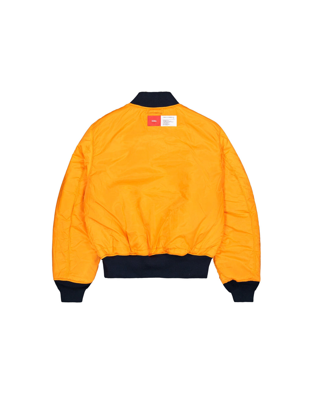Alpha X 032c Flight Bomber by Alpha Industries in bright orange flight nylon with black cuffs, collar, and waistband, featuring a white and red label near the collar.