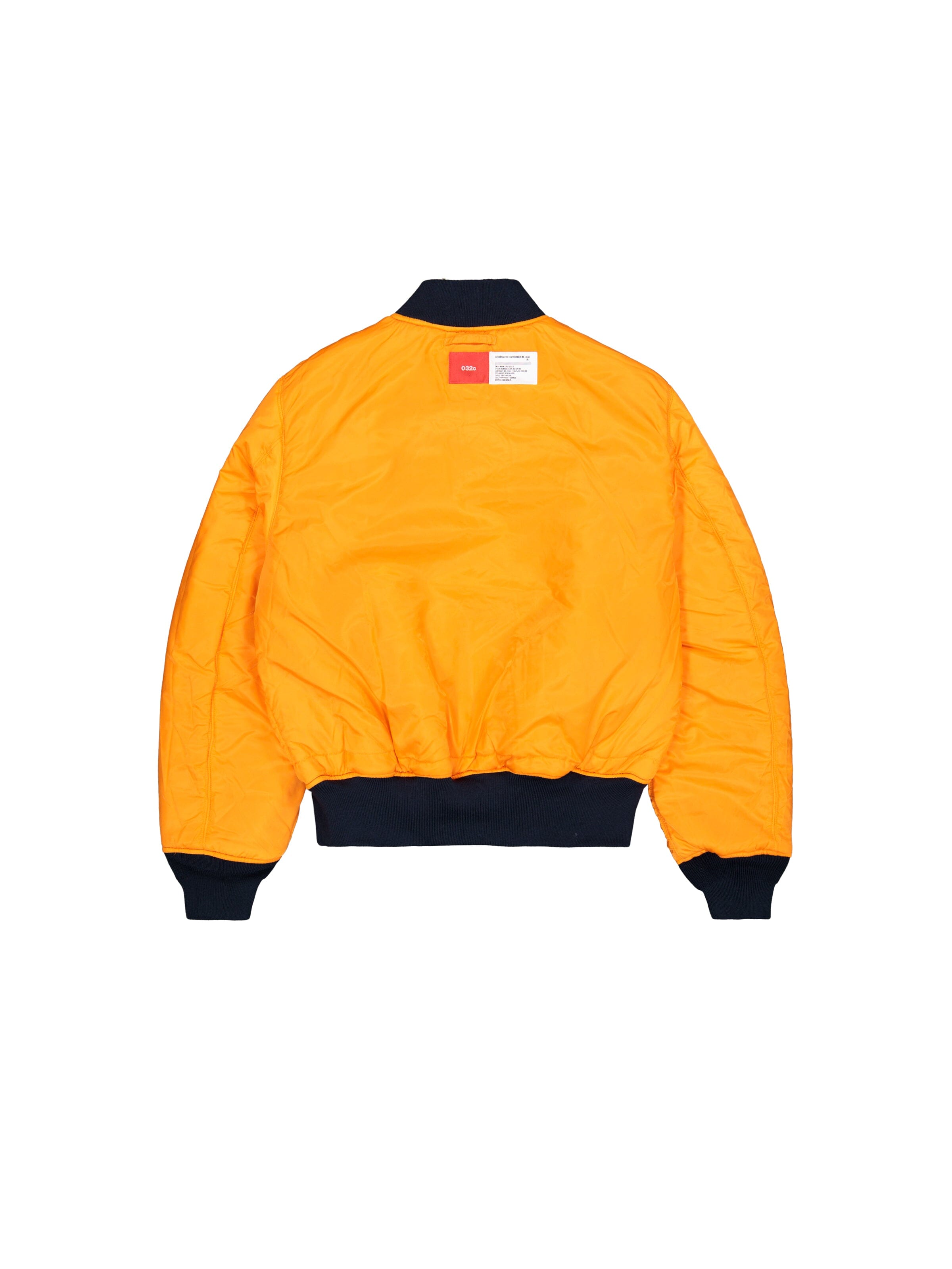 Alpha X 032c Flight Bomber by Alpha Industries in bright orange flight nylon with black cuffs, collar, and waistband, featuring a white and red label near the collar.