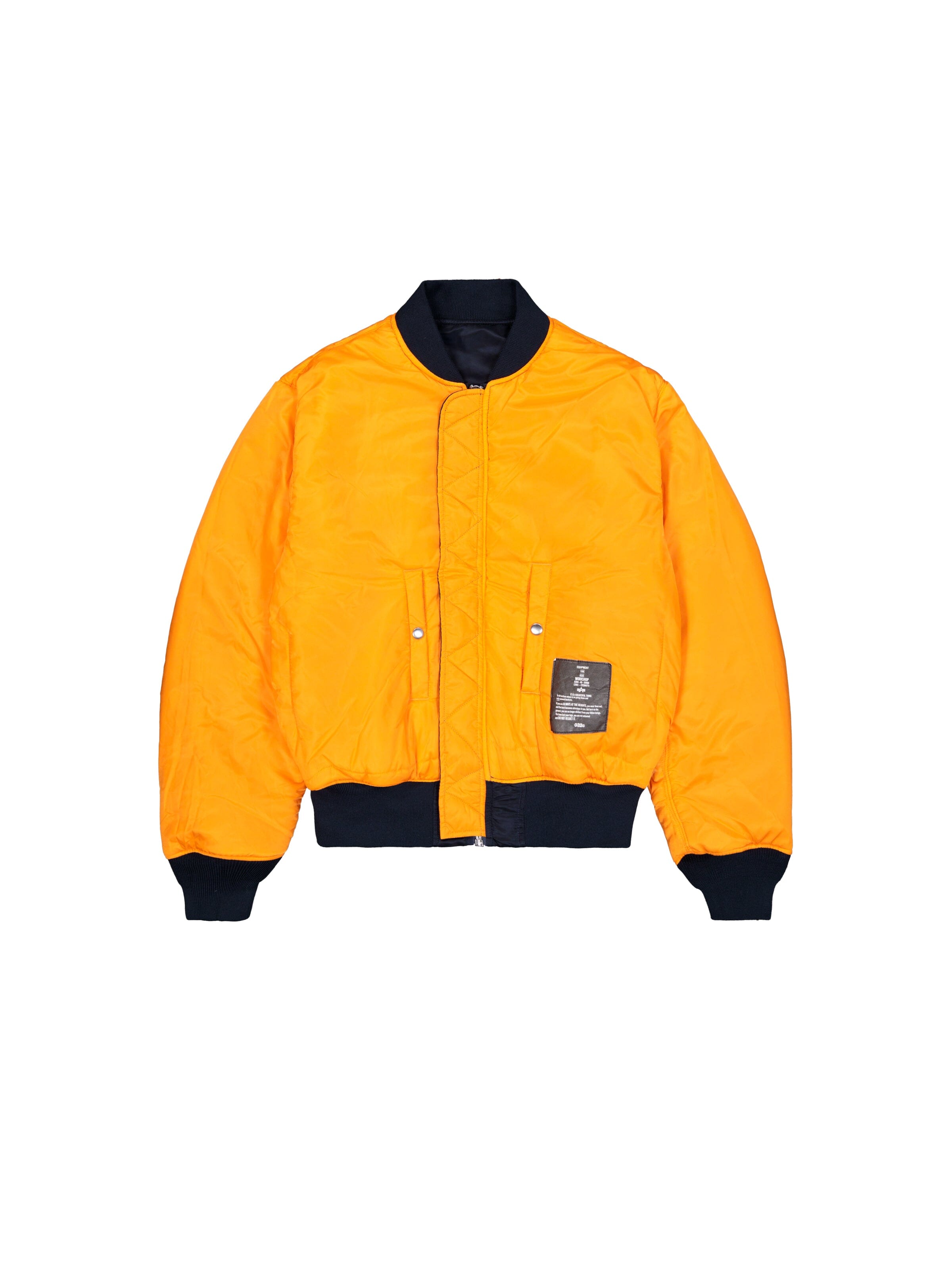 Alpha X 032C Flight Bomber by Alpha Industries, orange flight nylon jacket with black collar, cuffs, waistband, front pockets, and left-side patch.