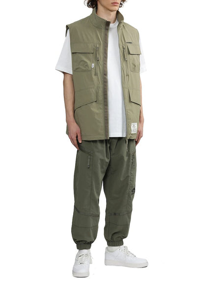 UNFRM Nylon Tactical Vest by Alpha Industries in olive green with utility pockets and zipper front.