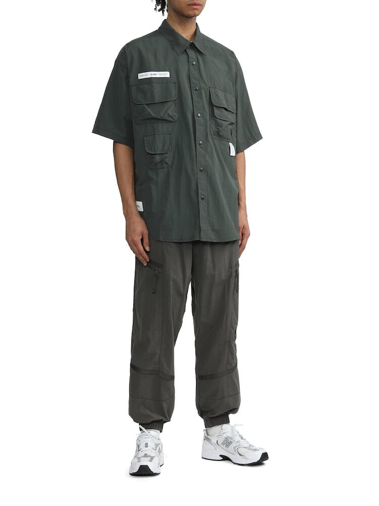 Alpha Industries Nylon Utility Shirt, dark green short-sleeve button-up with patch pockets and button front closures.
