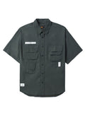 UNFRM Nylon Utility Shirt by Alpha Industries in teal, nylon material, short sleeves, button-up front, chest patch pockets, two lower front pockets, small white label with silicone Alpha print on left chest.