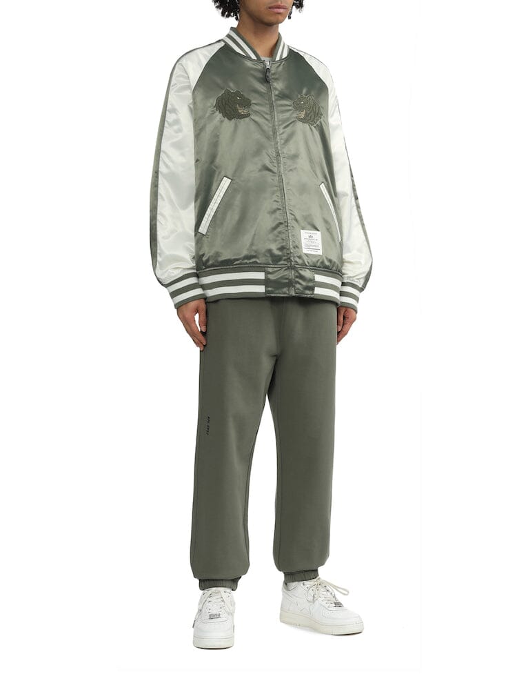 UNFRM Tiger Souvenir Jacket by Alpha Industries, black satin with embroidered tiger design, ribbed cuffs and hem, front snap closures.