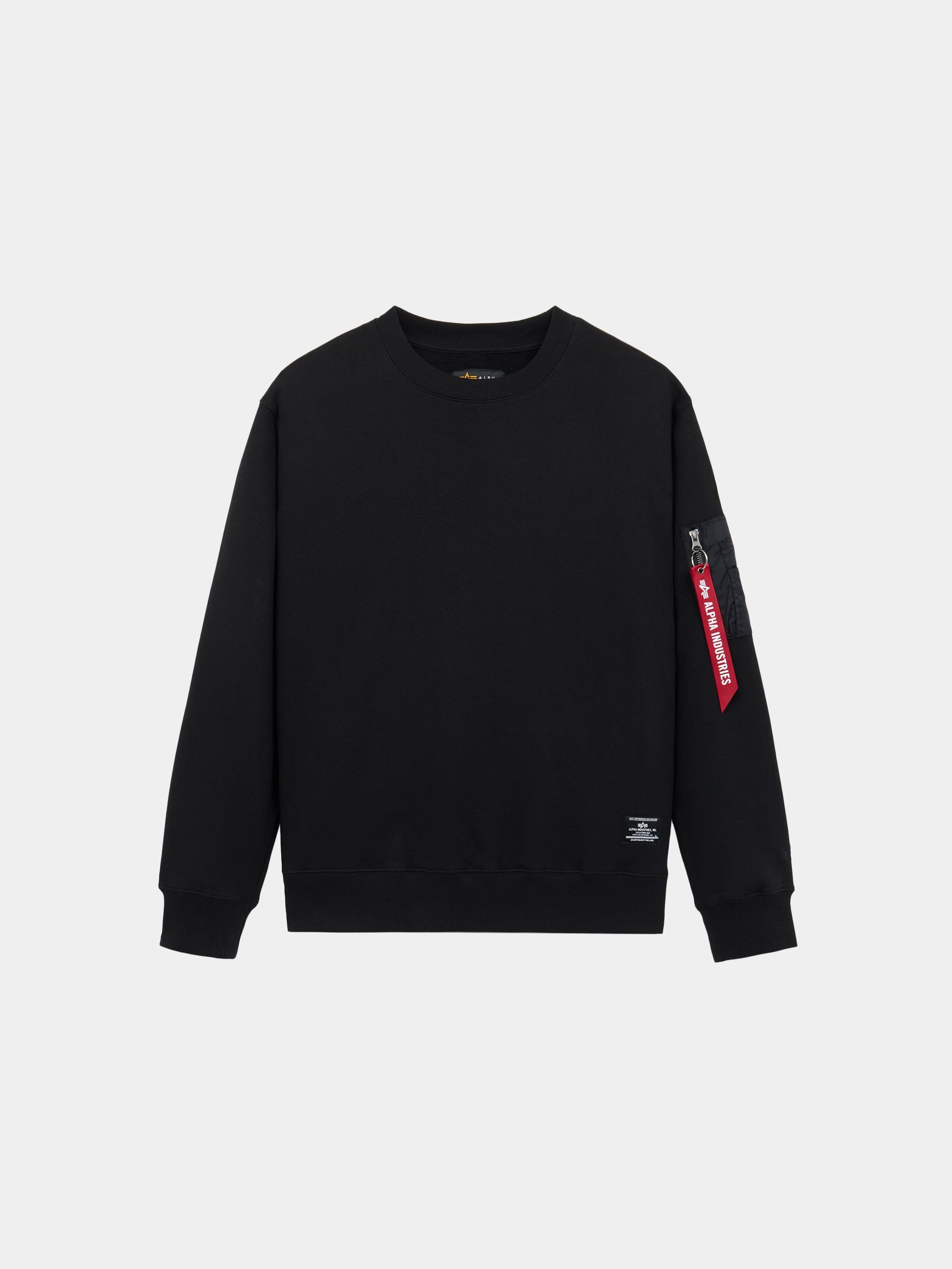 Alpha Industries Utility Pocket Crewneck in black with ribbed cuffs, hem, and MA-1 utility pocket on left sleeve with red tag.
