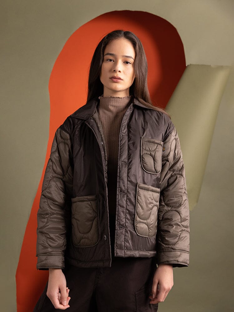 Upper body view of a person wearing the Women's Insulated Chore Coat in chocolate from Alpha Industries.