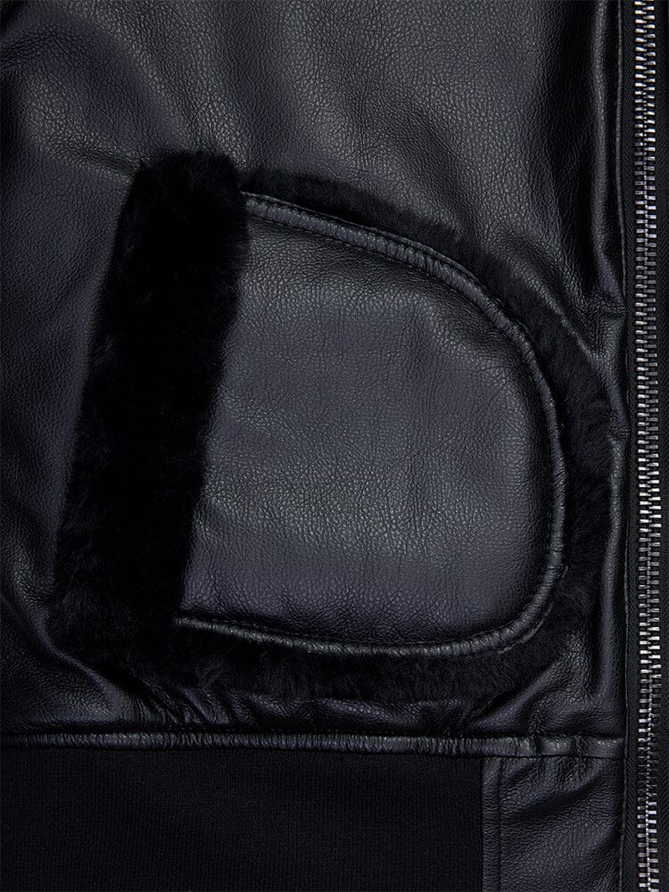 Close-up of the women's reversible faux leather MA-1 bomber jacket in black by Alpha Industries, featuring a shearling-lined pocket and prominent metal zipper.