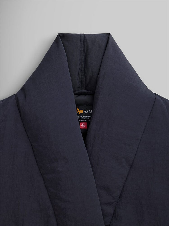 Close-up of the Women's Shawl Collar Bomber Jacket in black by Alpha Industries, showcasing its quilted design and sleek, dark look.