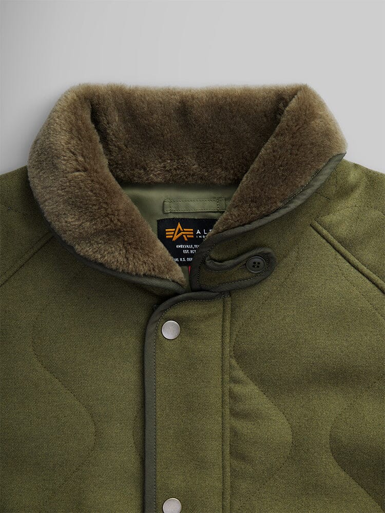 Close-up of the Wool Deck Jacket in olive green, styled like a classic deck jacket with a faux shearling collar, button closure, and quilted texture.