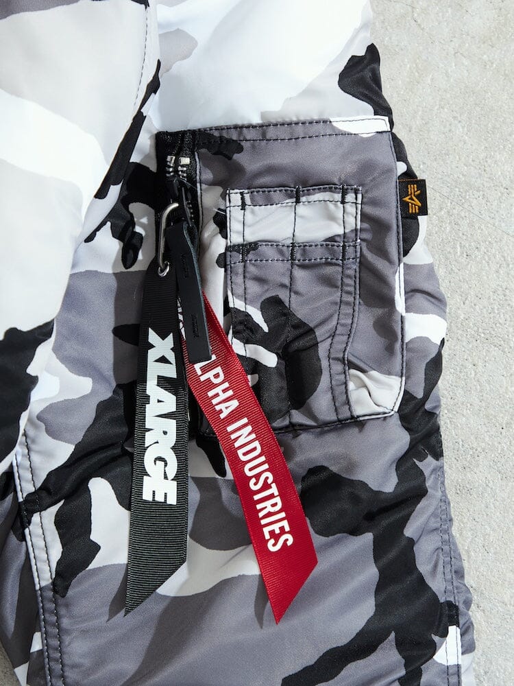 N-2B Core Spec Parka by Alpha Industries, camouflage-patterned water-repellent nylon, zippered pocket, black and red logo tags.