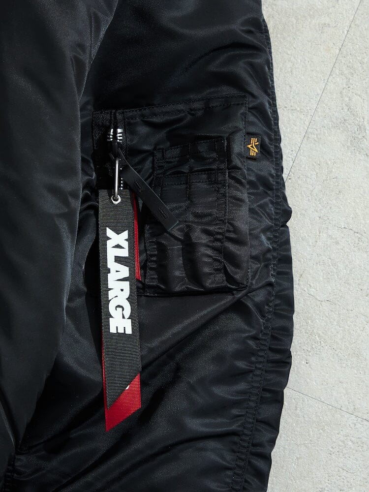 N-2B Core Spec Parka by Alpha Industries, water repellent nylon, zippered pocket, black and white Xlarge tag.