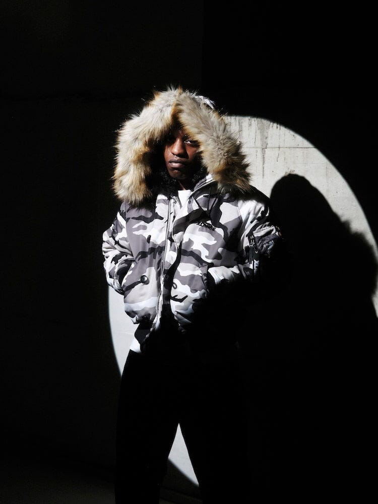N-2B Core Spec Parka by Alpha Industries, water-repellent nylon with synthetic mouton fur-lined hood, MA-1 utility pocket, front zipper closure.