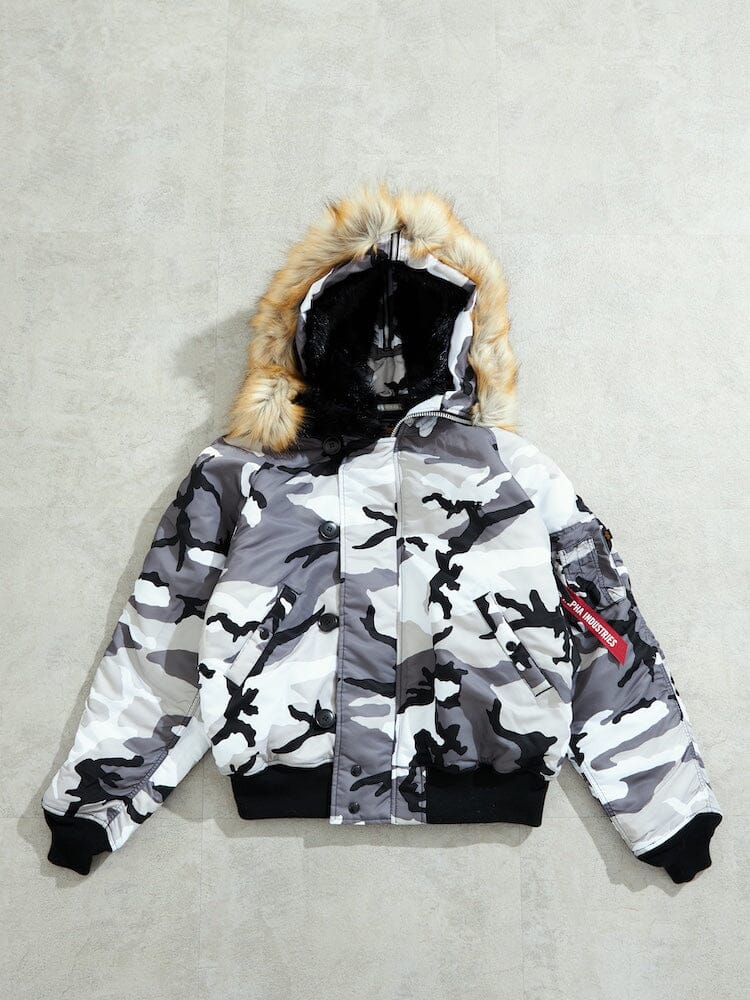 N-2B Core Spec Parka Alpha Industries, Black/White Camo, water-repellent nylon shell, synthetic mouton fur-lined hood, black cuffs.