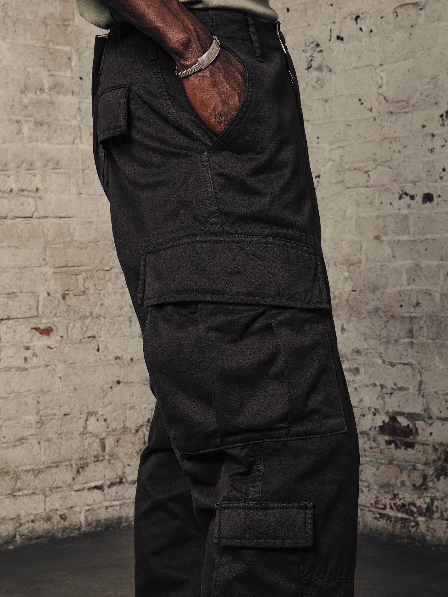 Alpha Industries ACU Pant, black cargo pants with utility pockets and nylon knee patches.
