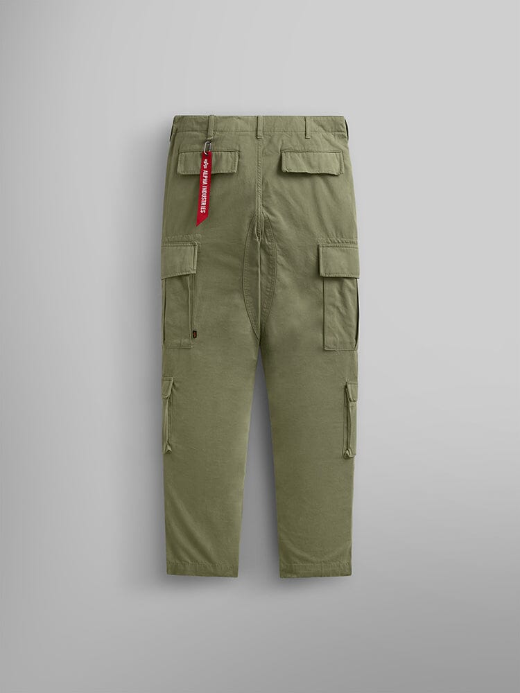 Alpha Industries Acu Pant in olive green with utility pockets, nylon knee patches, and red fabric tag on back belt loop.