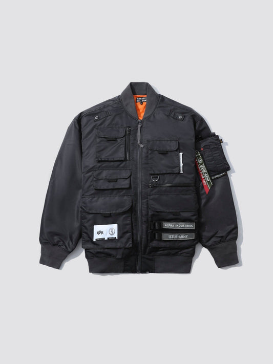 Alpha X Izzue Utility MA-1 Jacket by Alpha Industries in gunmetal with multiple front pockets, zip closure, patches, zippered sleeve pocket, tapered cuffs, and logo tag.