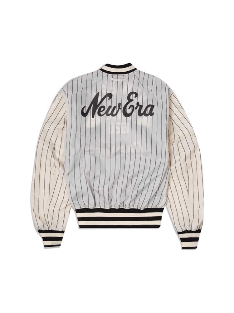 Introducing the Alpha X New Era L-2B Bomber Jacket by Alpha Industries: a stylish bomber jacket with a striped design and "New Era" text emblazoned on the back, showcasing a timeless black and white color palette. It features ribbed cuffs and a snug waistband for added comfort.