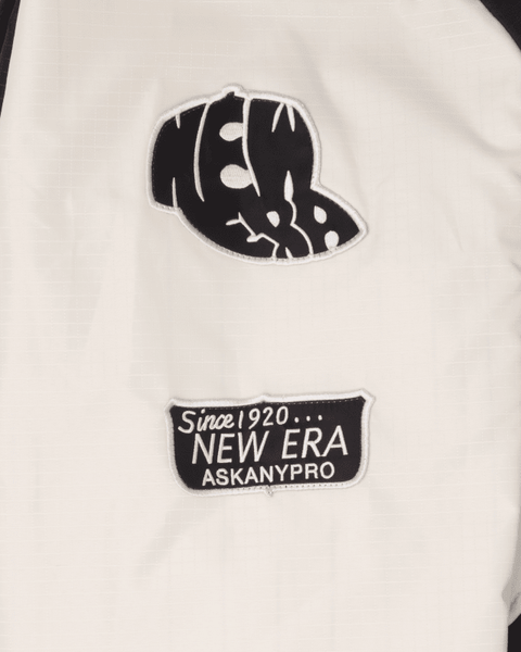 Close-up of the Alpha X New Era L-2B Bomber Jacket by Alpha Industries, highlighting two patches: a stylized New Era logo and a "Since 1920... New Era Ask Any Pro" text patch.