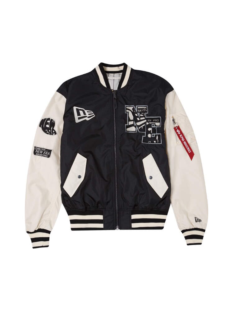 The Alpha x New Era L-2B Bomber Jacket by Alpha Industries in Black showcases an array of patches and designs embellishing the front and sleeves, along with a zip pocket on the left sleeve.