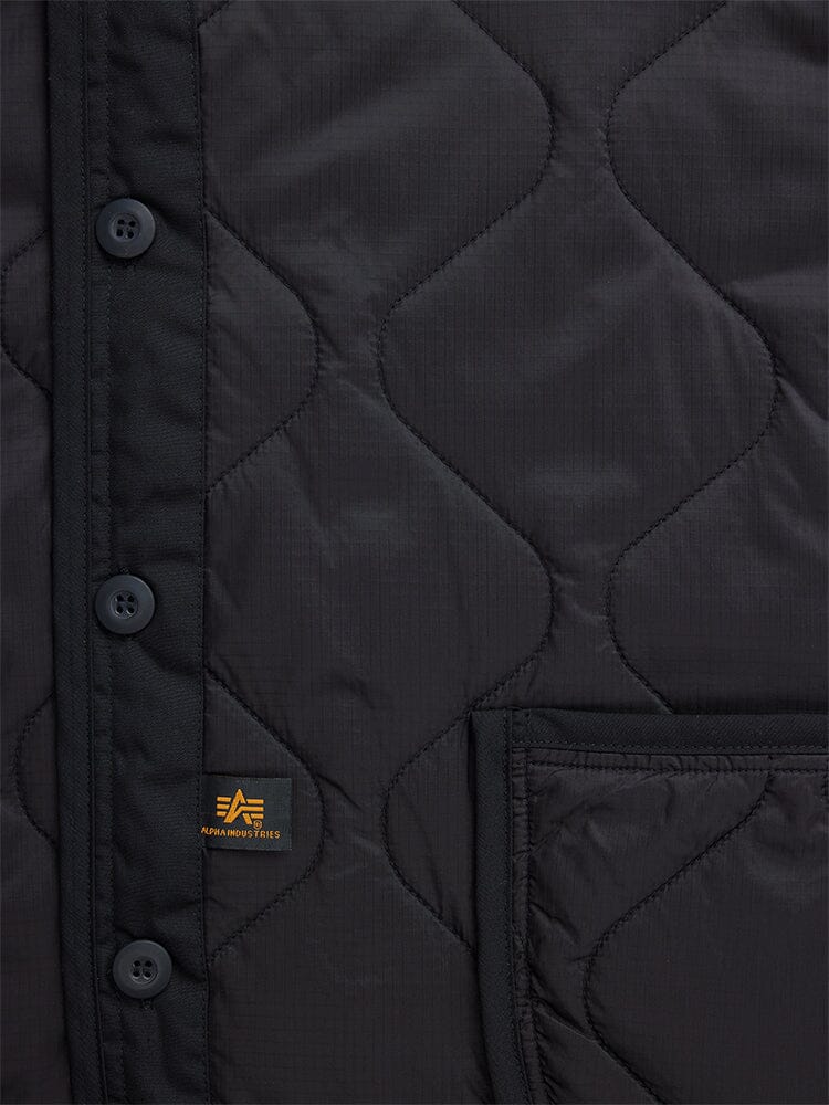 Alpha Industries Als/92 Liner, black quilted jacket with button placket, patch pocket, and small rectangular logo tag.