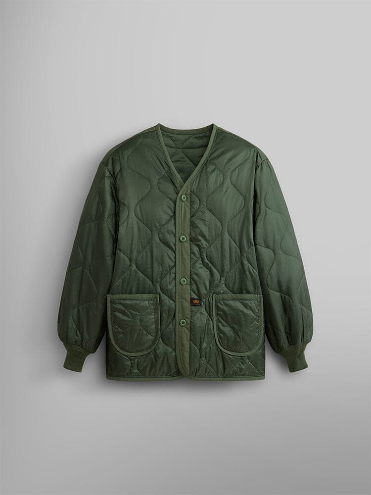 Alpha Industries Als/92 Liner in olive green with quilted design, button closure, two front pockets, and ribbed cuffs.