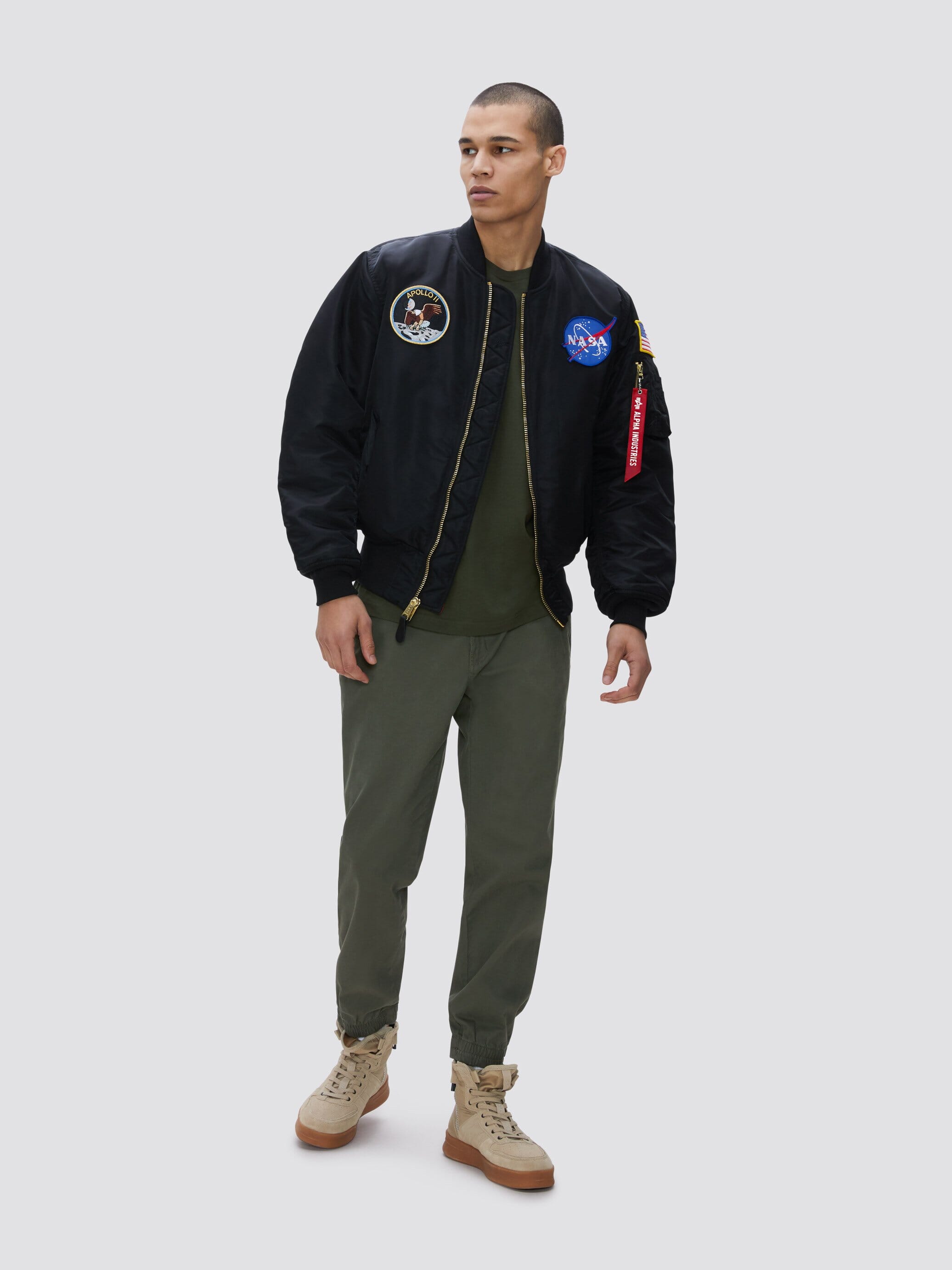 Alpha Industries MA-1 Bomber Jacket, olive green, nylon, Apollo mission patches, front zipper closure.