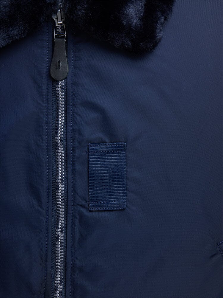 Alpha Industries B-15 Bomber Jacket in Navy Blue, Water-Resistant Finish, Visible Zipper, Small Rectangular Patch, Removable Faux-Mouton Collar.