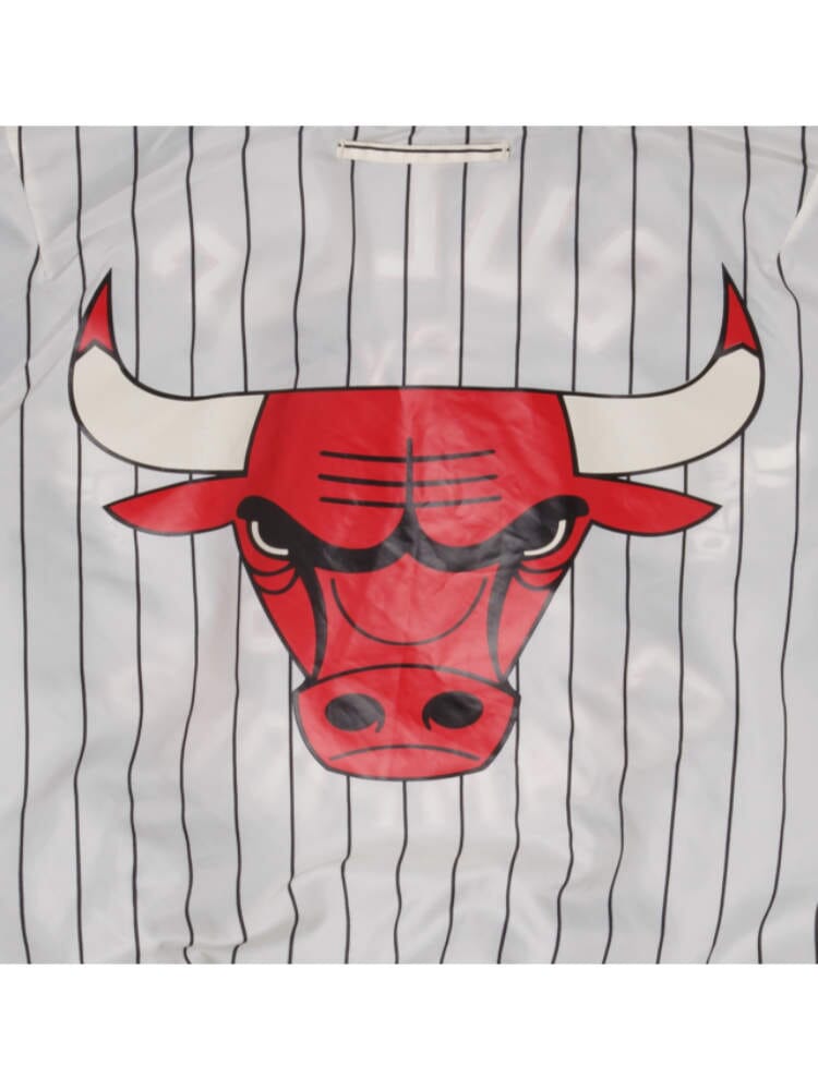 The bold spirit of the New Era collaboration is embodied in the Chicago Bulls x Alpha Industries x New Era L-2B Bomber Jacket, featuring a red bull with white horns and a fierce expression.