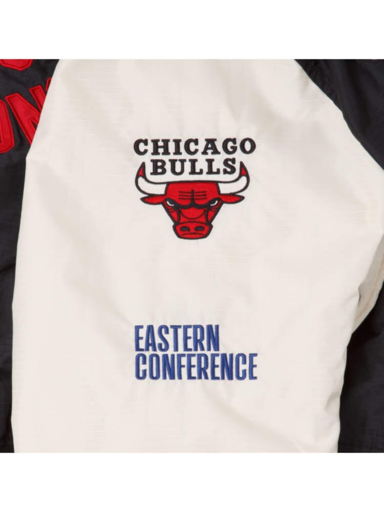 The Chicago Bulls x Alpha x New Era L-2B Bomber Jacket from Alpha Industries showcases a close-up of the Chicago Bulls logo along with "Eastern Conference," adorned with team patches from the New Era collaboration.