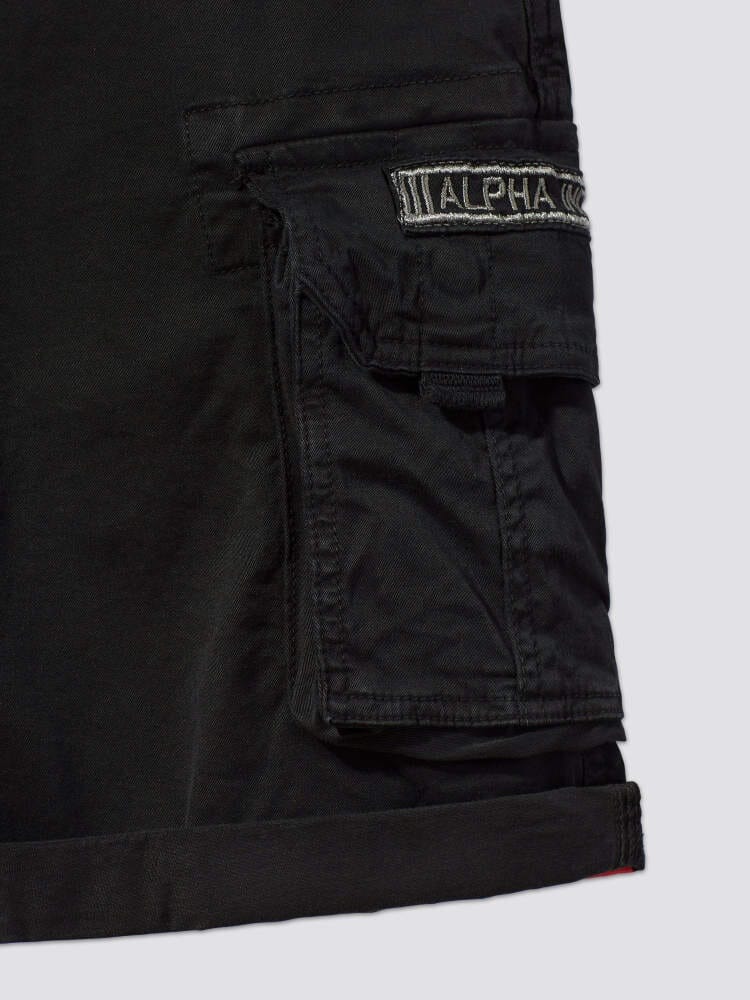 Crew Short Gen I by Alpha Industries, black lightweight cotton with cargo pocket, stitched ALPHA patch above pocket, visible seam details.