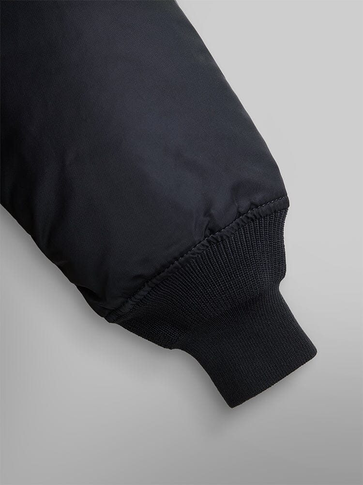 Alpha Industries Cwu 45/P Bomber Jacket in black, featuring a ribbed cuff on the sleeve.