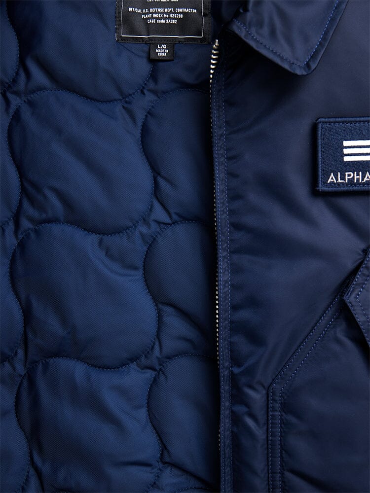Alpha Industries Cwu 45/P Bomber Jacket in navy blue, partially unzipped to show interior lining and collar label.
