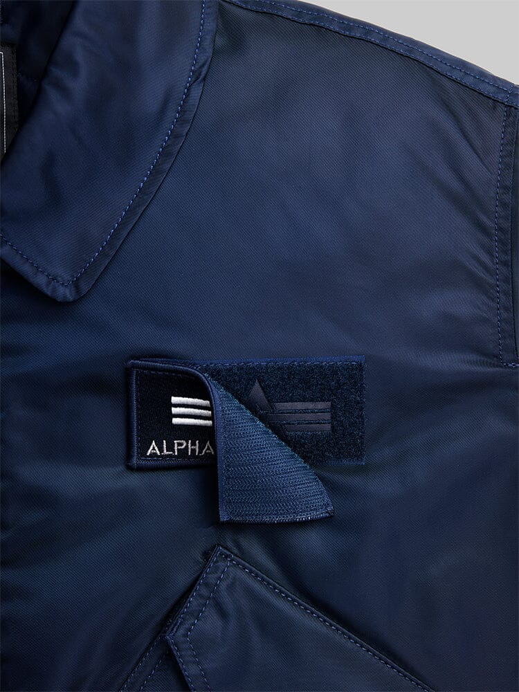 Navy Blue Cwu 45/P Bomber Jacket by Alpha Industries with Velcro Patch and Alpha Industries Logo Embroidered on the Patch.