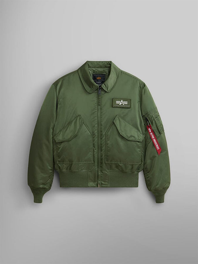 Alpha Industries Cwu 45/P Bomber Jacket in Sage Green with front zipper, two flap pockets, left chest patch, and red Remove Before Flight sleeve tag.