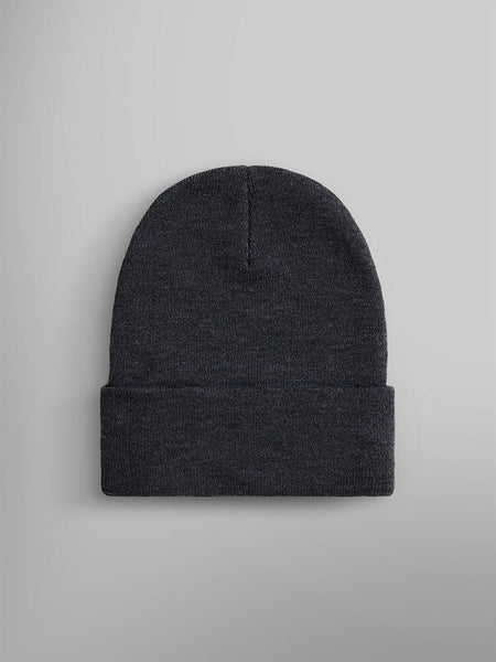 The Essential Beanie by Alpha Industries, Inc. features a plain dark gray knit design with a folded cuff and is enhanced with a subtle paper label for added style.