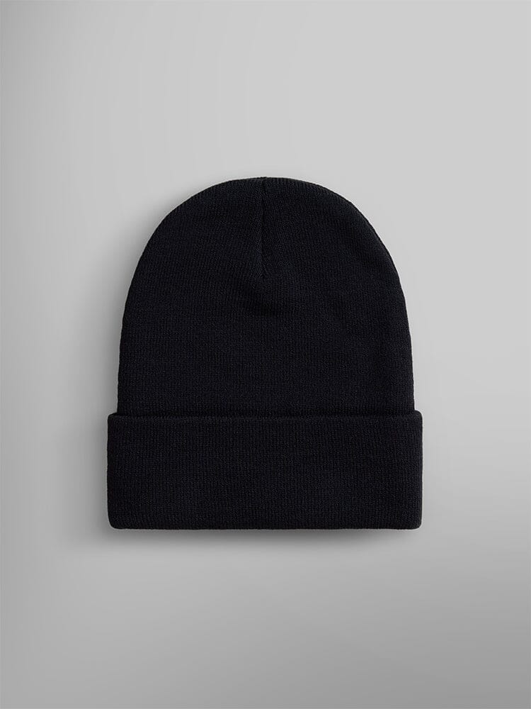 An Essential Beanie in plain black knit featuring an Alpha Industries, Inc. paper label on the folded brim.