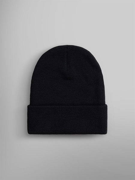 An Essential Beanie in plain black knit featuring an Alpha Industries, Inc. paper label on the folded brim.