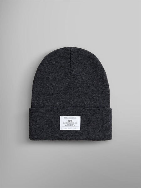 The Essential Beanie, in a Dark Charcoal Heather shade, features a folded brim with an Alpha Industries, Inc. label subtly sewn on the front.