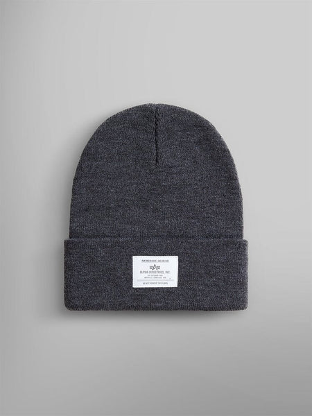 Medium charcoal heather knit beanie with a folded brim and an Alpha Industries paper label on the front, known as the Essential Beanie.