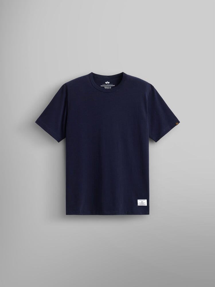 Alpha Industries Essential Tee, navy blue cotton shirt with small white label on lower left front hem.