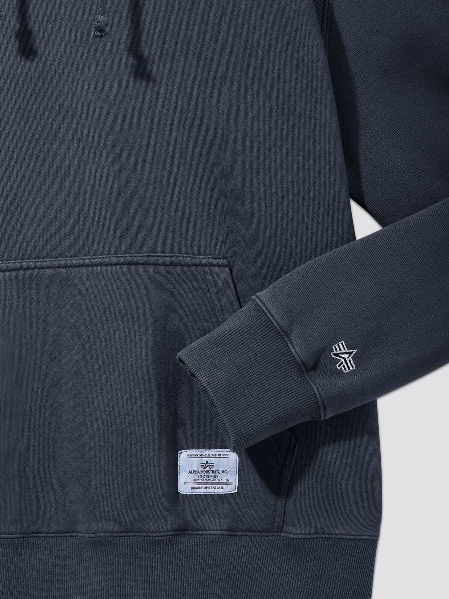 Alpha Industries Essential Washed Hoodie in dark gray, front pocket, white hem tag, embroidered sleeve logo.