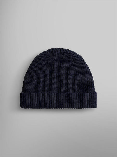 Back view os an essential watch cap in a dark blue wool blend with a folded brim, by Alpha Industries.