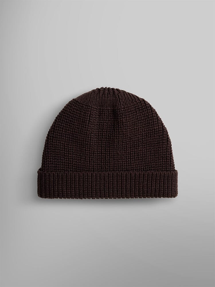 The Essential Watch Cap by Alpha Industries is showcased. This cap features a folded brim and is crafted from a dark brown wool-blend material.