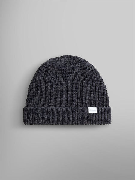 The Essential Watch Cap by Alpha Industries, in a dark charcoal heather wool-blend, features a folded cuff and a small white label, evoking the timeless style of a classic watch cap.