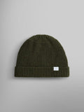 A wool-blend watch cap in olive color featuring a folded brim and a small white label on the front, by Alpha Industries, named the Essential Watch Cap.