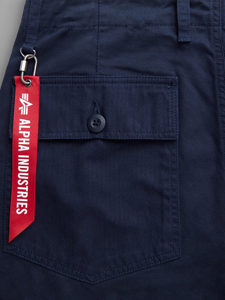 Fatigue Pant by Alpha Industries, navy blue cotton pocket with button closure, utility pockets, red Alpha Industries tag on metal keyring.