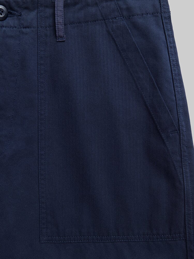 Alpha Industries Fatigue Pant in navy blue cotton with side utility pocket, visible stitching, and buttoned waistband.